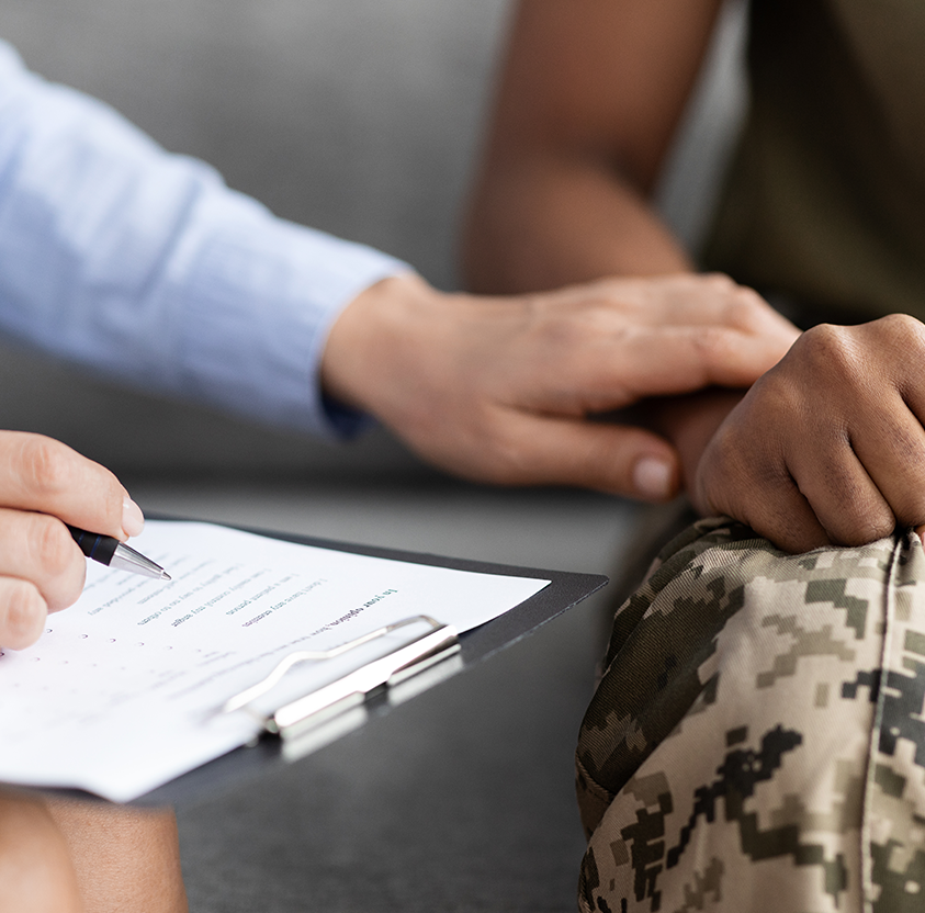 Closeup shot psychotherapist supporting african american soldier woman therapy session