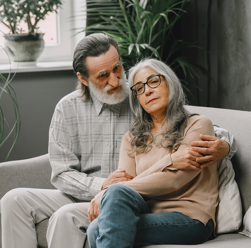 Happy senior couple sitting couch home talking quality time concept