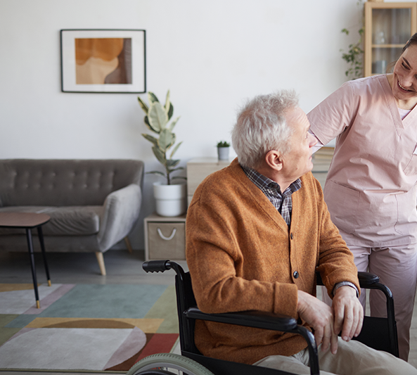 Portrait smiling female nurse helping senior man wheelchair retirement home copy
