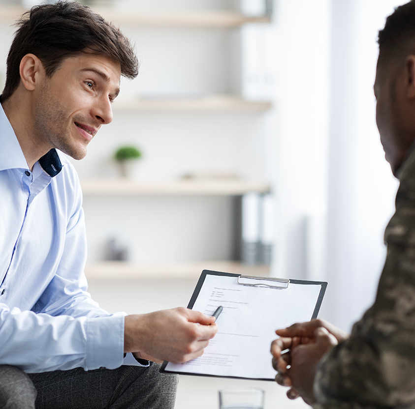 Psychologist giving african american military man recommendations