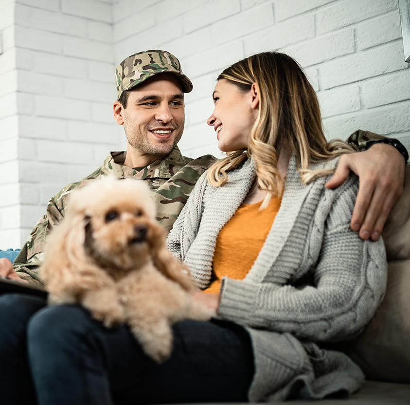 Young happy army soldier his wife talking each other while using